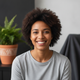 Portrait of a young woman in her late 20s, smiling confidently.